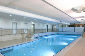 a large swimming pool in a building at FEWO-Luik H-1-6 in Heiligenhafen