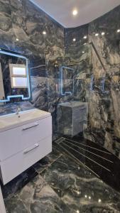 a bathroom with a sink and a mirror at Villa Wilaya of Tétouan in Tetouan