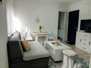a living room with a couch and a table at Apartman Nera in Gradačac