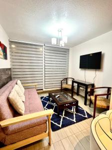 a living room with a couch and a table at Entorno Natural, cerca del centro de Pucón Parking Privado in Pucón