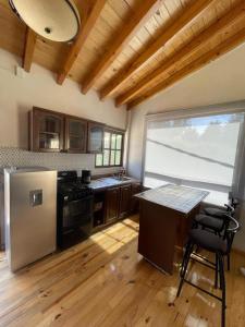 a kitchen with a refrigerator and a table in it at Cabañas los Cedros in Santiago Oxtempan +31 photos
