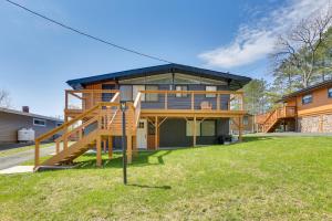 a house with a deck and a staircase in the yard at Walk to Kauneonga Lake Home with Deck and Grill in White Lake