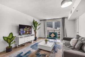 a living room with a couch and a tv at Enjoy Brickell Living 2 BR Retreat With Free Parking in Miami