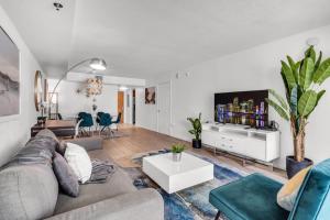 a living room with a couch and a table at Enjoy Brickell Living 2 BR Retreat With Free Parking in Miami