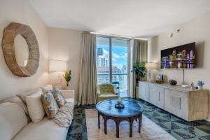 a living room with a couch and a table at Icon Brickell Gem 2-BR Oasis with Amazing Views in Miami
