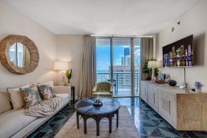 a living room with a couch and a table at Icon Brickell Gem 2-BR Oasis with Amazing Views in Miami