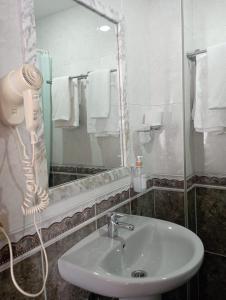 a bathroom with a sink and a blow dryer at Puente Azud in Avilés