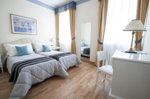 Posteľ alebo postele v izbe v ubytovaní Hotel Villa Erica