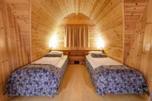 a room with two beds in a log cabin at Snow Resort Kirkenes in Kirkenes +95 photos