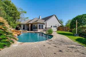 a house with a swimming pool in the yard at Near Cynthia Woods Mitchell Pavilion Family Home! in The Woodlands