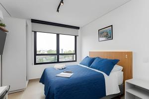 Postel nebo postele na pokoji v ubytování Apartamentos modernos próximo ao Jardim Botanico e à Rodoviária