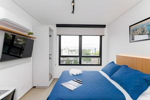 Postel nebo postele na pokoji v ubytování Apartamentos modernos próximo ao Jardim Botanico e à Rodoviária