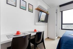 TV a/nebo společenská místnost v ubytování Apartamentos modernos próximo ao Jardim Botanico e à Rodoviária