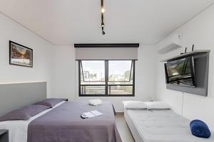 Postel nebo postele na pokoji v ubytování Apartamentos modernos próximo ao Jardim Botanico e à Rodoviária + 37 fotografií