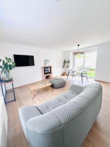 a living room with a couch and a table at Maison entièrement rénovée Plérin centre in Plérin +15 photos