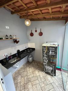 a kitchen with a sink and a counter top at Casa da Vila in Monte Alegre do Sul
