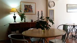 a dining room table with a vase of flowers on it at Acropolis Hotel in Korinthos