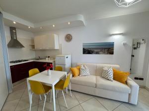 a living room and kitchen with a couch and a table at Il Nido di Cervia in Cervia