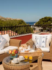 a tray of food on a table on a patio at Hotel Cala Sant Vicenç - Adults Only in Cala de Sant Vicenc
