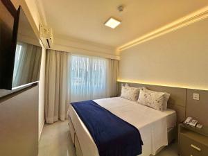 a bedroom with a large bed with a window at The Palace Flat Moema - UH303 in Sao Paulo +11 photos