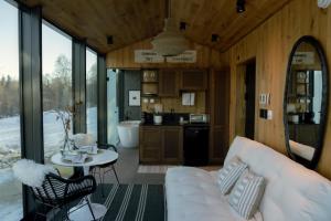 a living room with a couch and a table at Wilding Hotels Fairbanks in Fairbanks