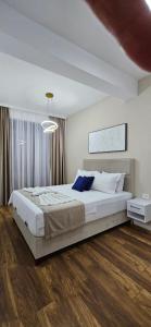 a bedroom with a large bed in a room at Bahr DELUX App & Suite in Ulcinj