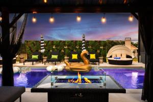 a room with a pool with a fire pit at Designer Home with Hot Tub BBQ & Hill Views in Driftwood +46 photos