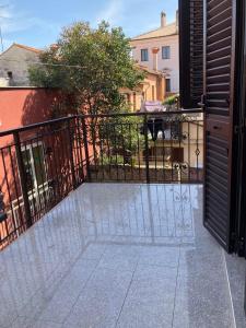 a balcony with a black gate and a building at Barbabianca Apartment in Koper