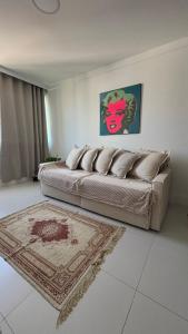 a living room with a bed and a rug at Luxury 3 minutes from the Porto da Barra beach - Fast Wi-Fi, new apartment in Salvador