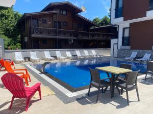 a patio with chairs and a table and a pool at Ağva Capella Hideaway Hotel in Şile