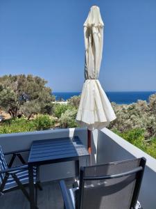 a table and chairs on a balcony with the ocean at Santa Rosa house in Lichnaftia