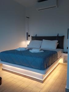 a bed with a blue comforter in a room at Santa Rosa house in Lichnaftia