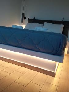 a bed with a blue comforter on top of it at Santa Rosa house in Lichnaftia +23 photos