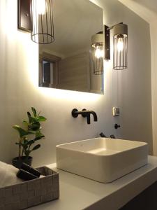 a bathroom with a white sink and a mirror at Santa Rosa house in Lichnaftia