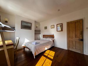 a bedroom with a bed and a wooden door at The OX1 in Oxford