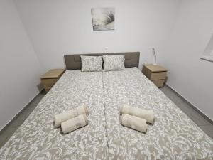 a bedroom with a large bed with two pillows at Apartma Zala in Brežice +16 photos