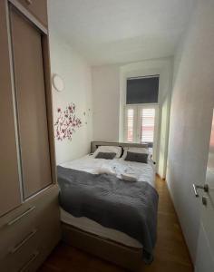 a bedroom with a bed in a room with a window at Barbabianca Apartment in Koper