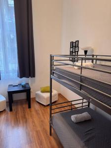 a room with two bunk beds and a table at Enios Rooms Hostel Zwierzyniecka 6 in Kraków