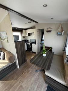 a living room with a table in a tiny house at 163 Holiday Resort Unity Brean sands Pet friendly in Berrow