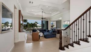 a living room with a staircase with a blue couch at Hollyhock in Marco Island