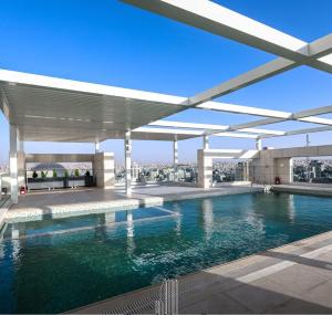 a swimming pool on the roof of a building at Boulevard Abdali view Luxury apartment in Amman