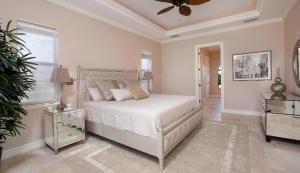 a white bedroom with a bed and a window at Shenandoah in Marco Island +19 photos