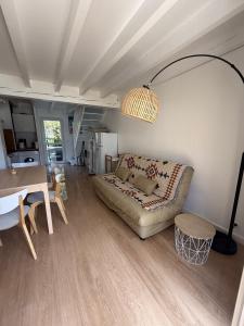 a living room with a couch and a table at Duplex résidence avec piscine sur Anglet in Anglet