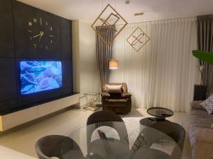 a living room with a large tv and a couch at Boulevard Abdali view Luxury apartment in Amman