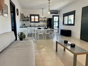 a living room and kitchen with a couch and a table at Casa Posidonia in Korinthos