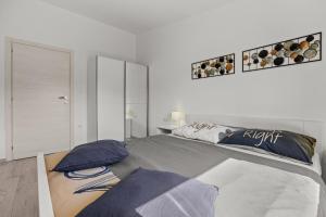 a white bedroom with a bed with pillows on it at House Kacana in Vodnjan