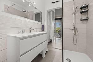 a white bathroom with a sink and a shower at House Kacana in Vodnjan +39 photos