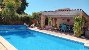a swimming pool in a yard with a house at La berraudiere in Saint-Martin-dʼArdèche