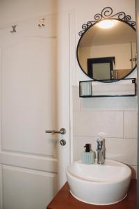 a bathroom with a white sink and a mirror at Villa Lando in Peruški +15 photos
