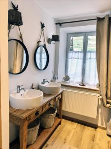 a bathroom with two sinks and mirrors on the wall at Gîte de Charme nature, calme, randonnée et air pur in Le Valtin +25 photos